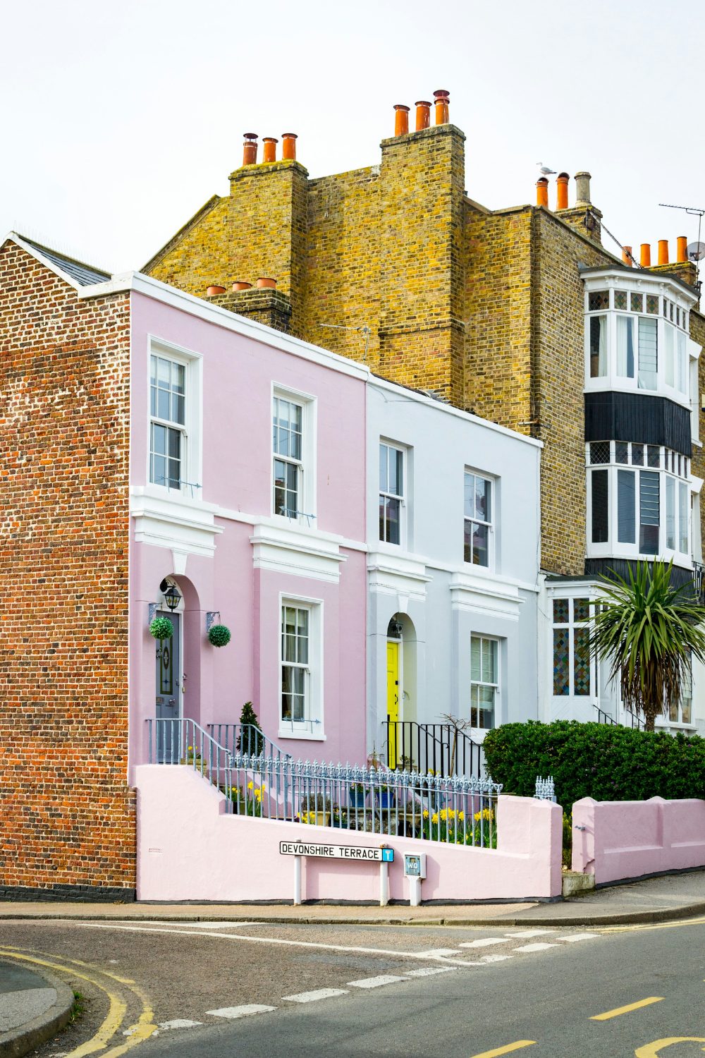 Pastel coloured terraced houses on a city street corner