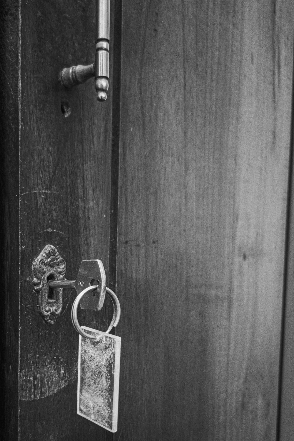 Close-up of a metal key in a black front door