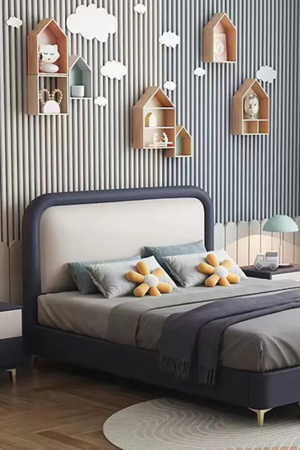 Navy bed with flower cushions and wooden feature wall