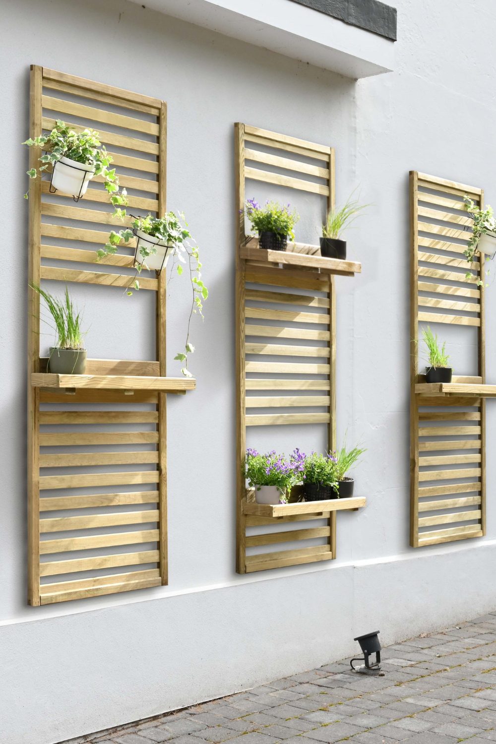 Pale wood shelves on outside wall with potted plants