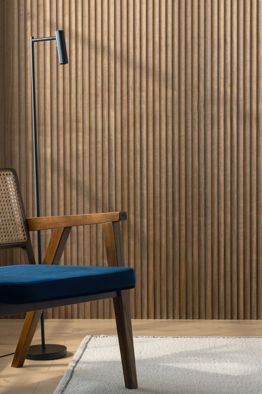 Corrugated wooden feature wall with blue chair and lamp