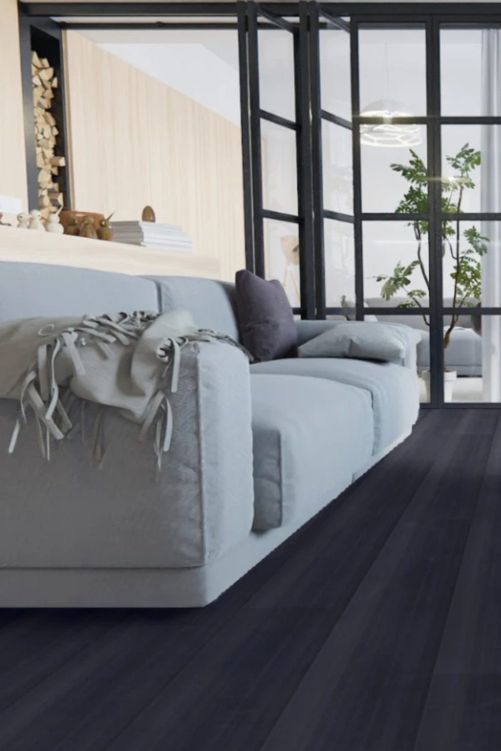 Grey sofa on a black wood floor with black metal and glass shutters and a light wood wall