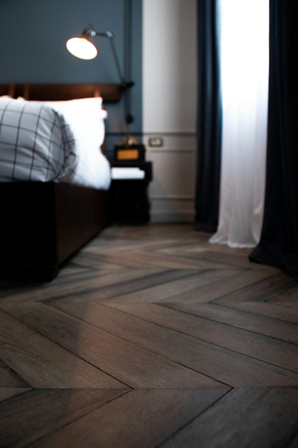 Dark blue bedroom with wooden parquet flooring