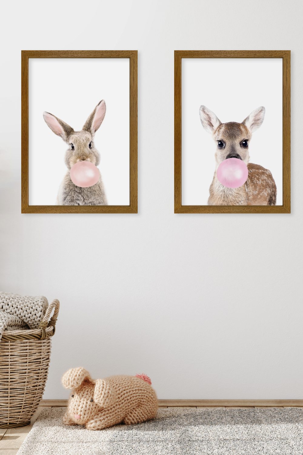 Two framed animal prints above a wicker storage basket and knitted rabbit toy