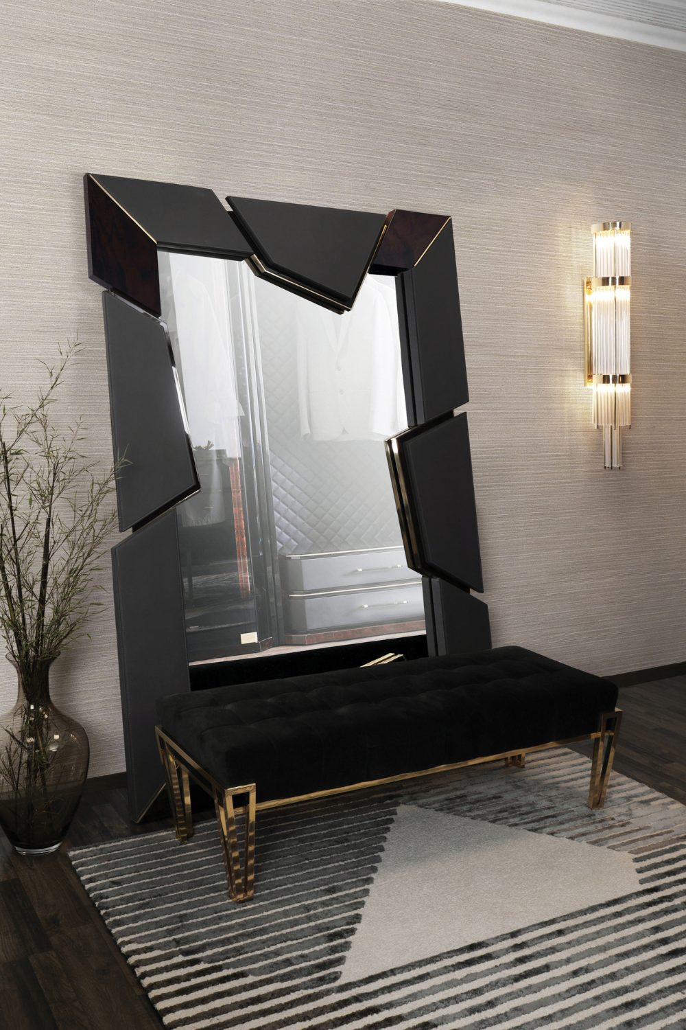 Black-framed mirror behind a black bench and geometric rug