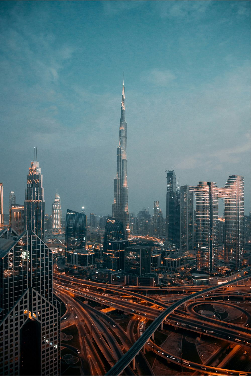 Dubai skyscrapers at night with complex road system in front