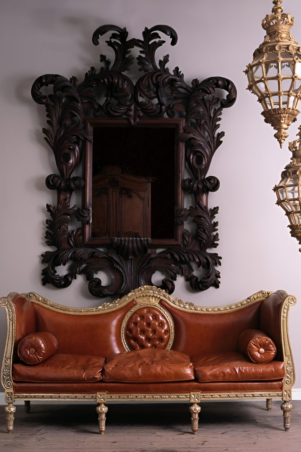 Ornate red and gold sofa in front of large decorated black curlicue mirror and gold lanterns