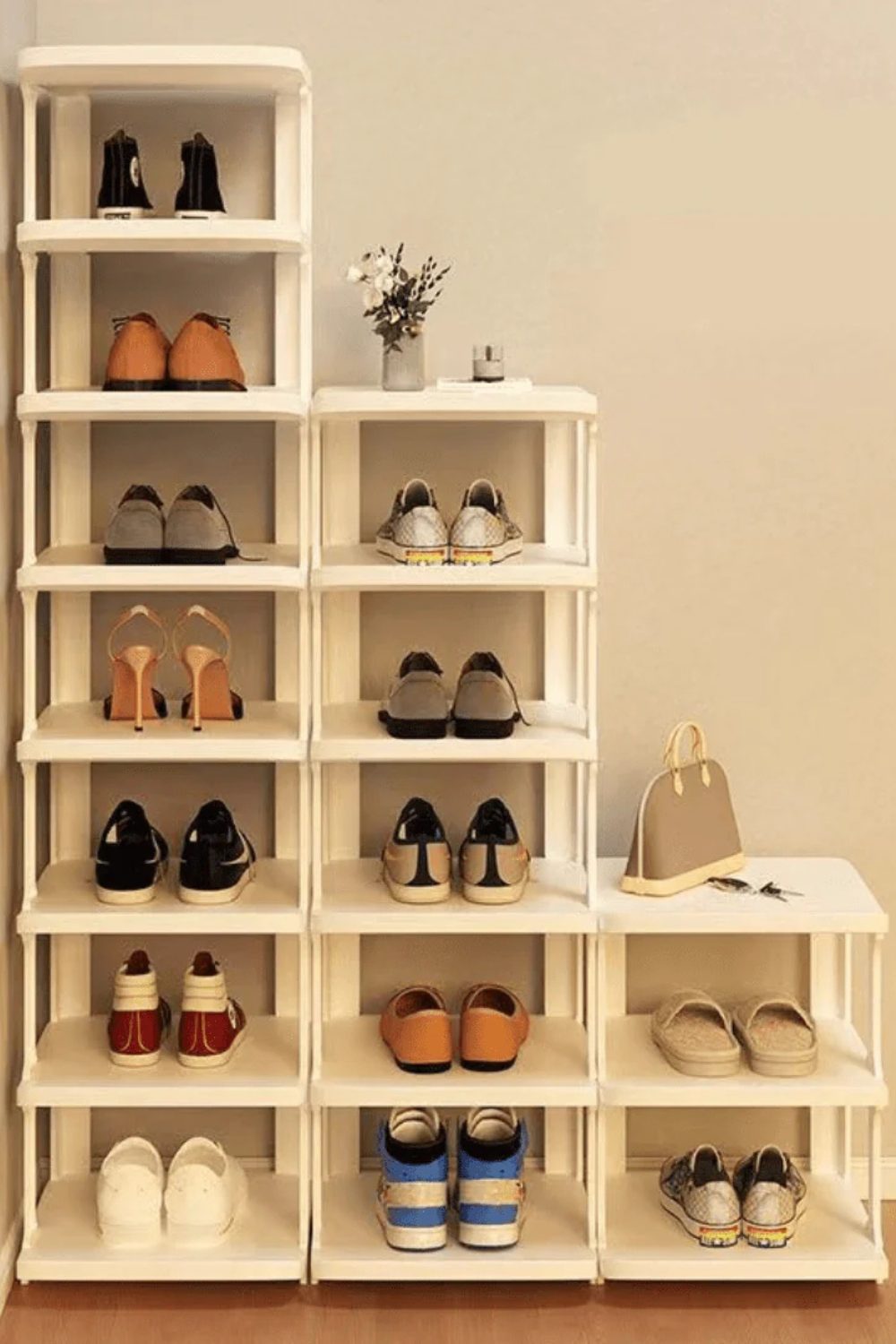 White shoe rack with pairs of shoes neatly stored on open shelves