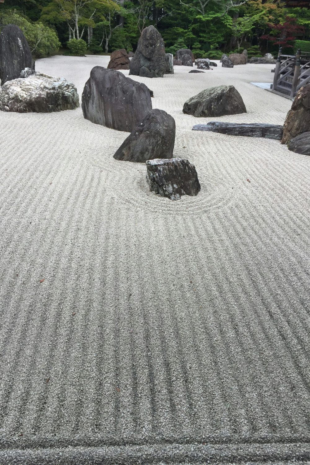 Japanese garden with grey gravel raked around several large rocks
