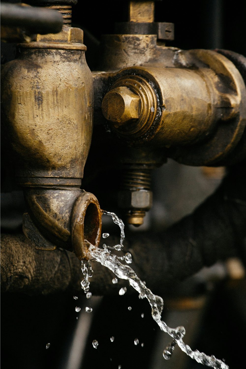 Industrial brass tap with stream of water