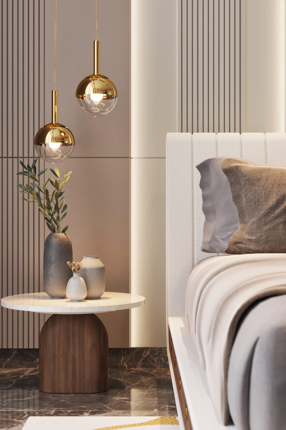 Round table holding vases next to white and brown bed, under gold hanging lamps