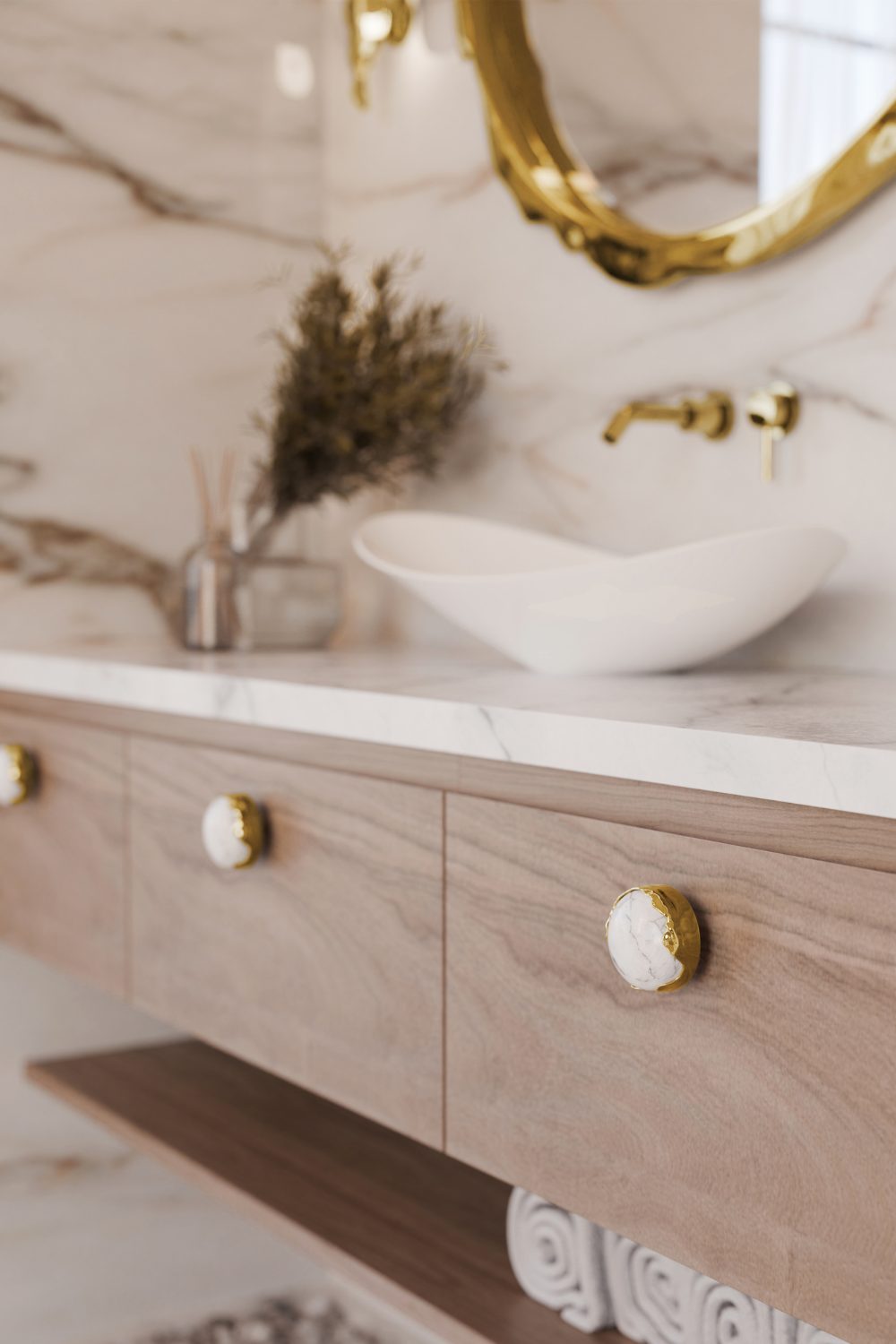 Wooden bathroom cabinets with white and gold handles under gold mirror and white marble counter and sink