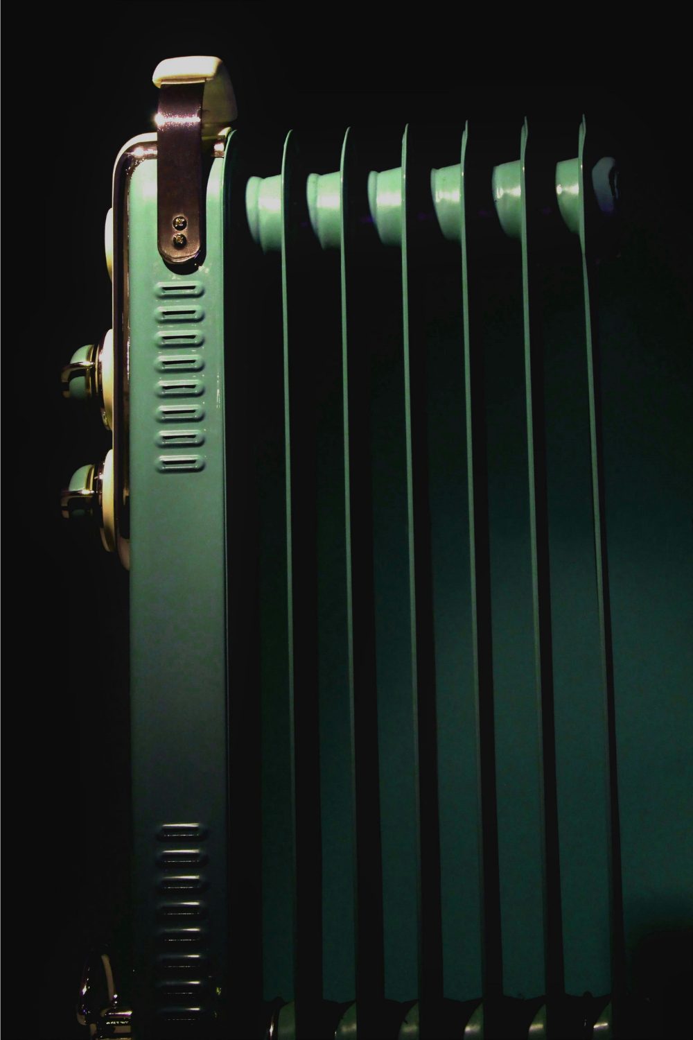 Green metal radiator against black background