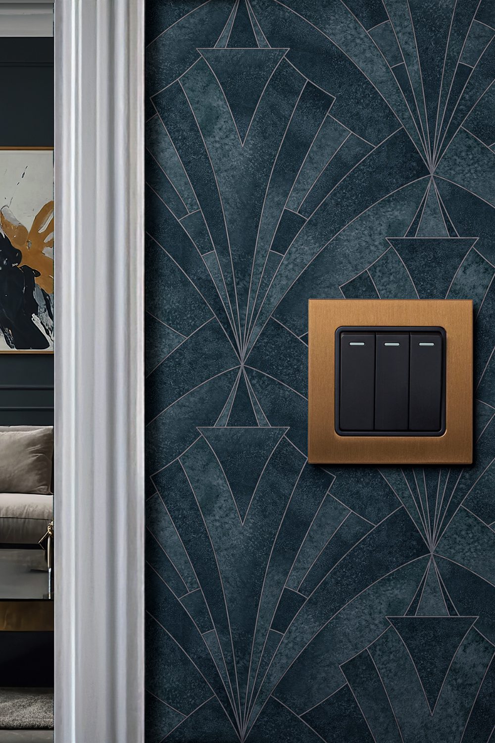 Gold and black light switch on blue art deco wallpaper