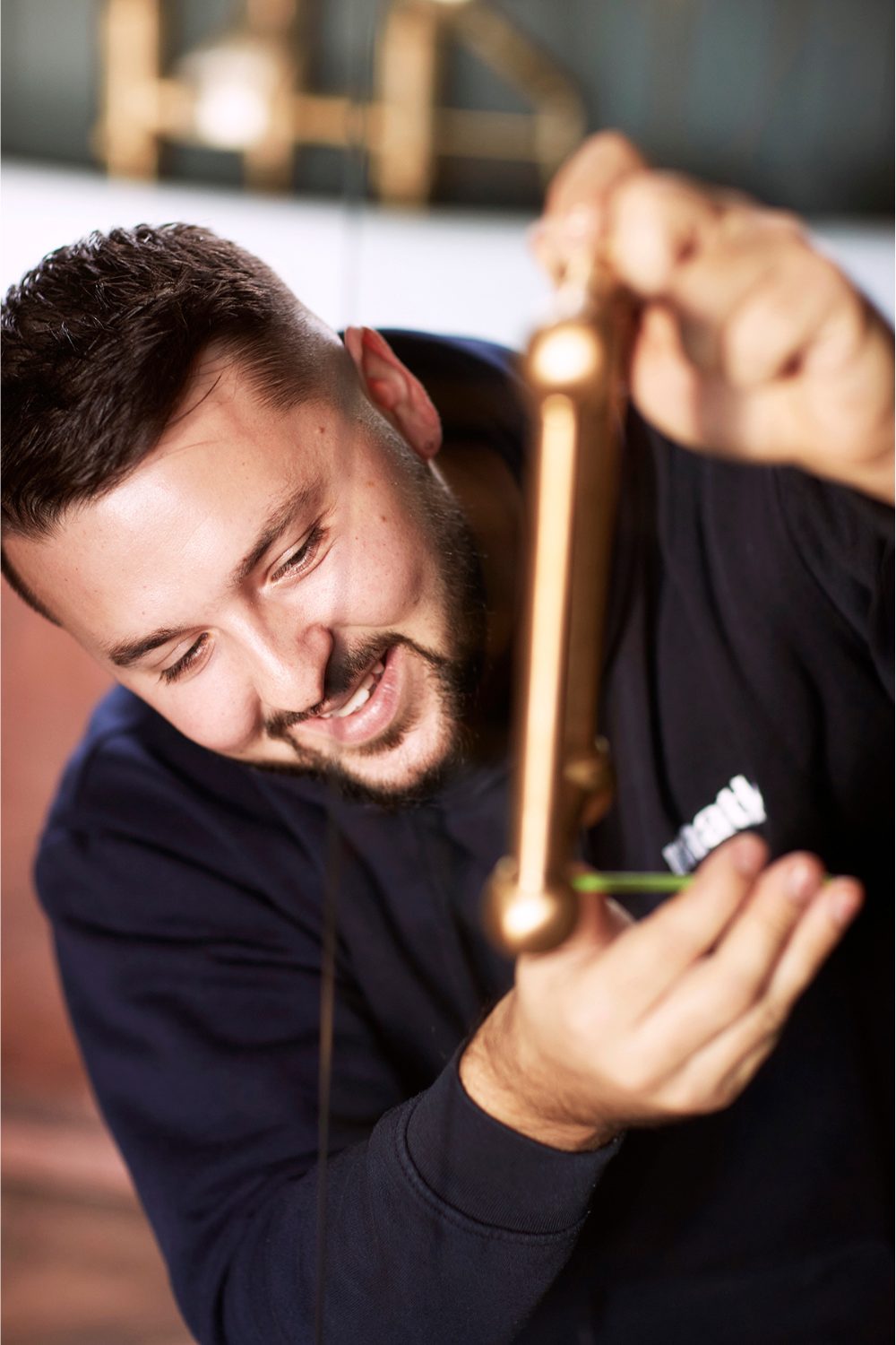 Man holding glass panel with brass handle