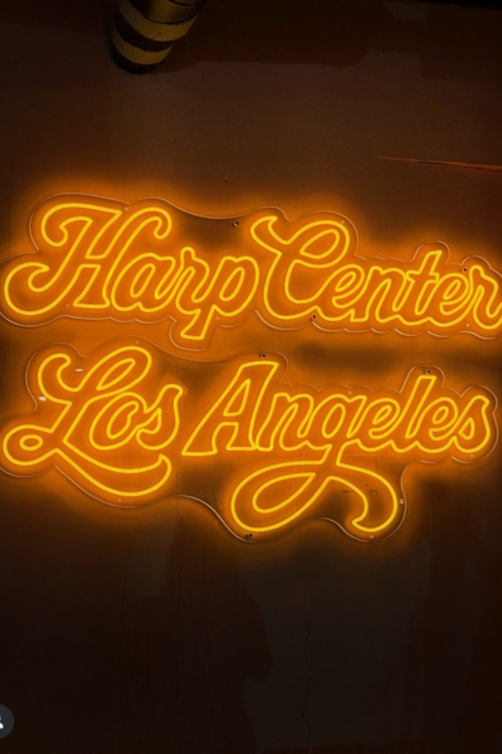Orange neon sign reading Harp Center Los Angeles