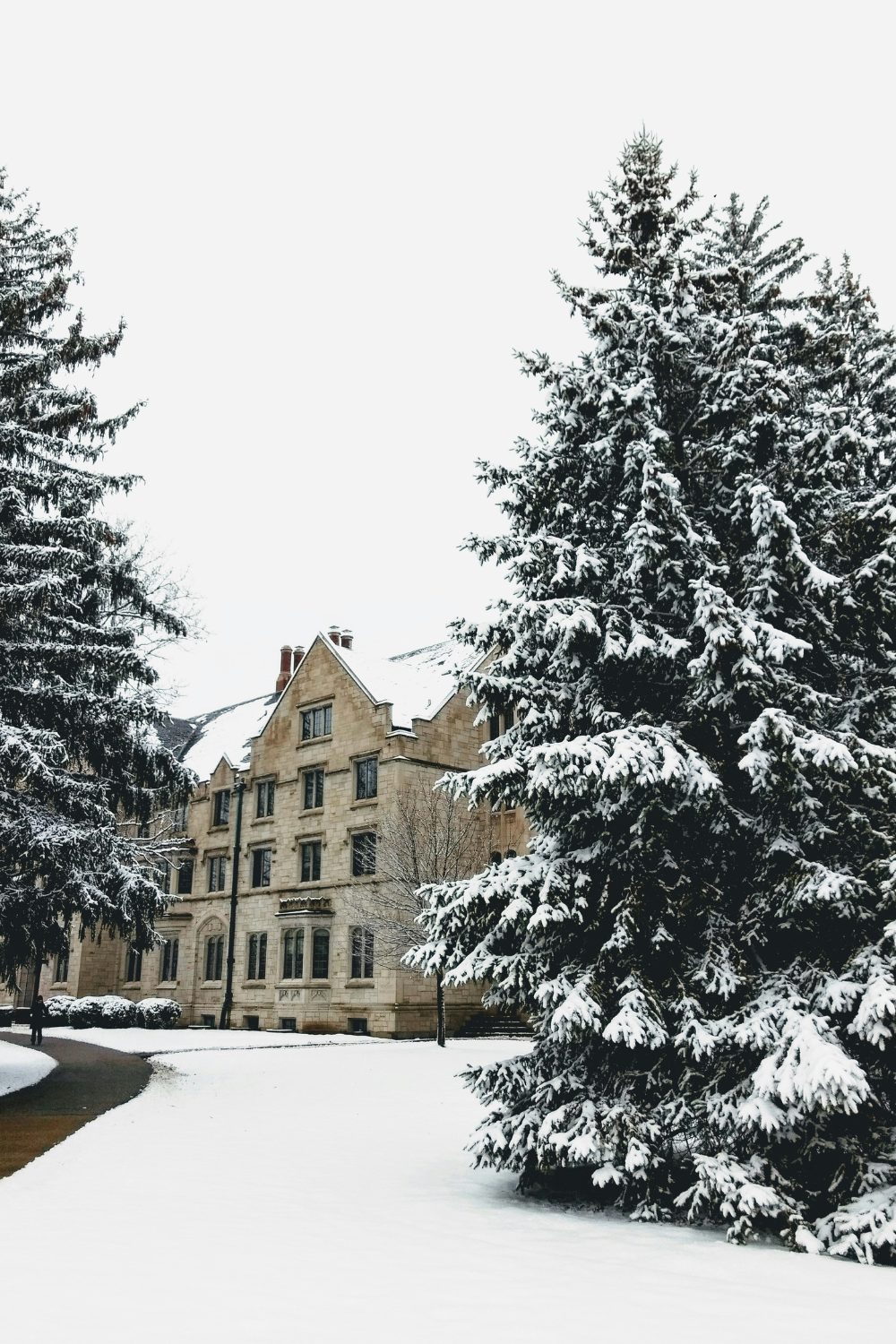 American university dorm building surrounded by snowy grounds and trees