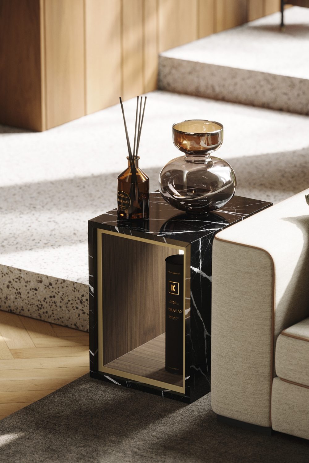 White sofa with black marble side table holding diffuser sticks and metal decanter