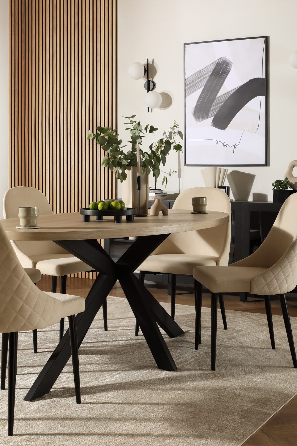 Neutral dining room with wooden table, padded chairs, wooden slat feature wall and framed minimalist print