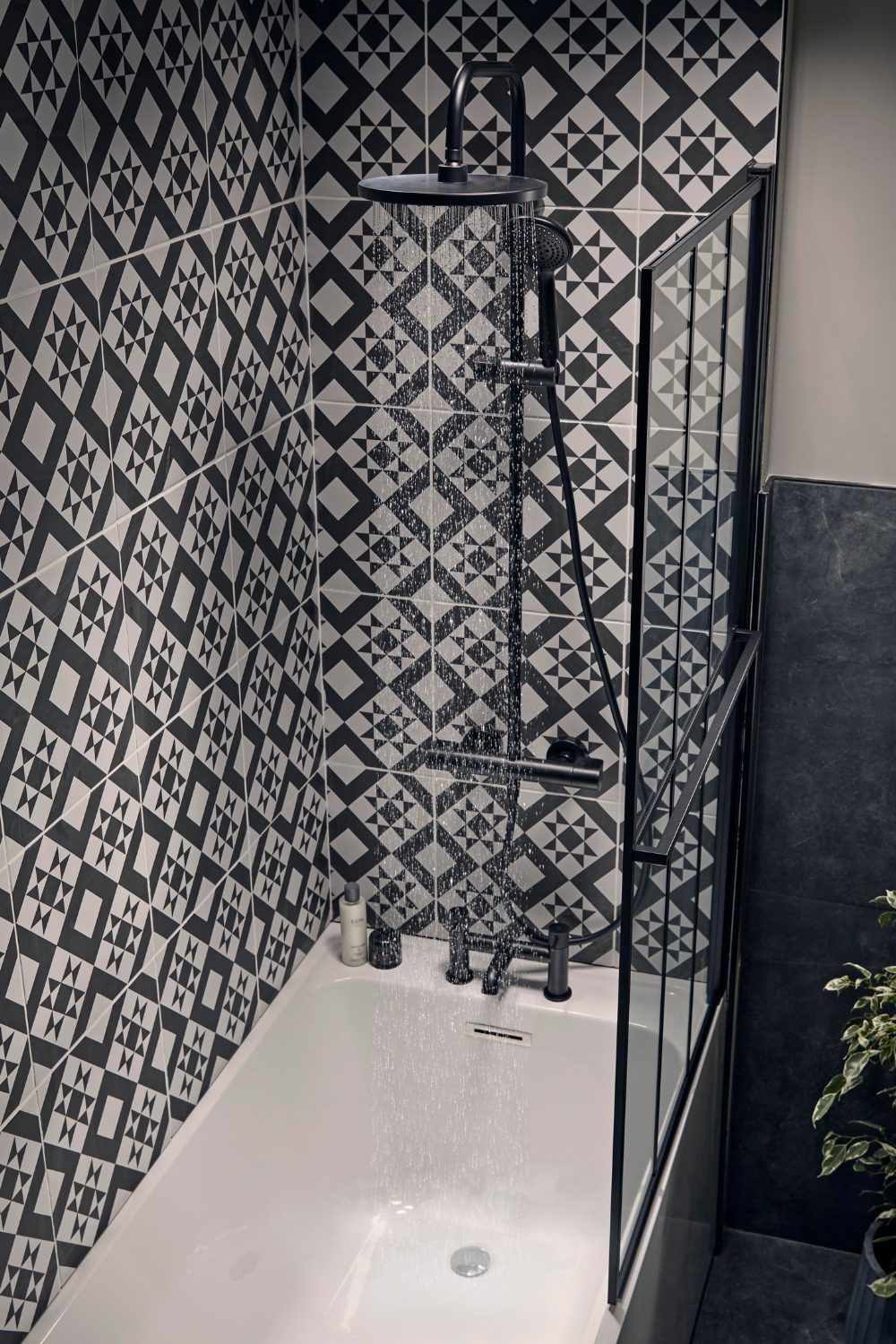 Shower with black and white patterned tiles
