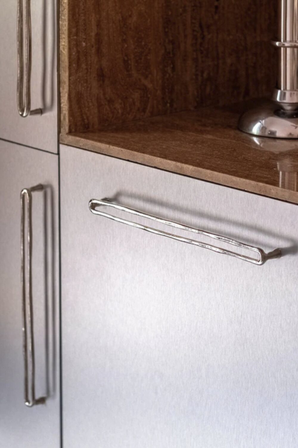 Grey kitchen cabinets with long sculptural handles