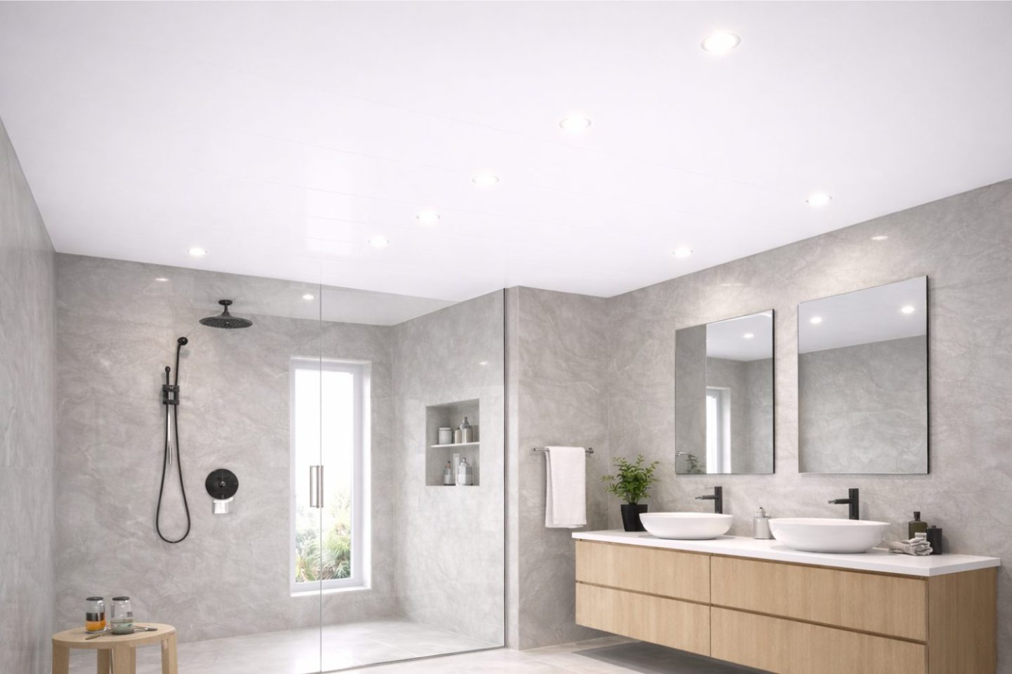 Grey bathroom with walk-in shower, double sink and mirrors.