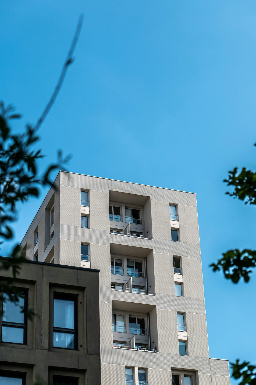 Grey flat buildings against blue sky
