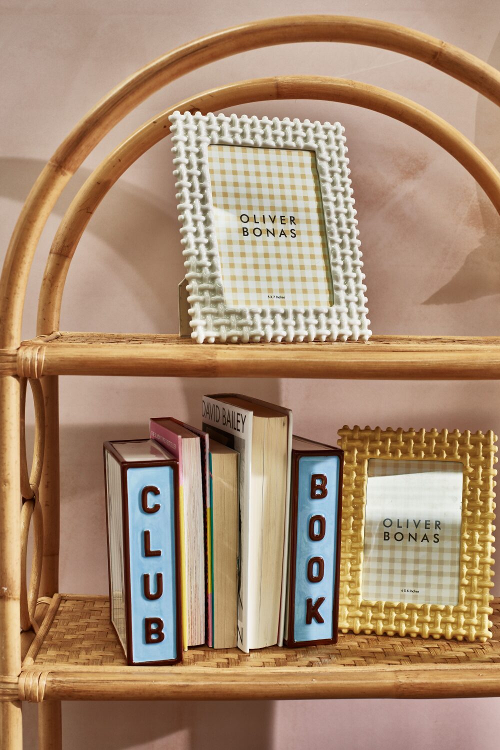 Wicket shelves holding books and textured photoframes