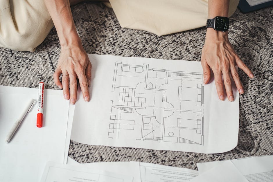 Planning drawings for a UK home extension on a desk