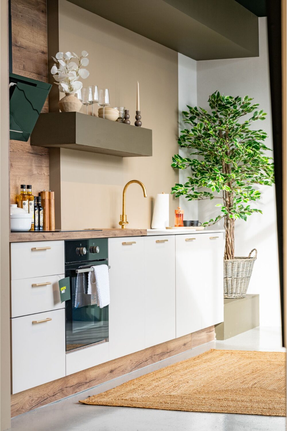 White kitchen with potted tree and jute rug