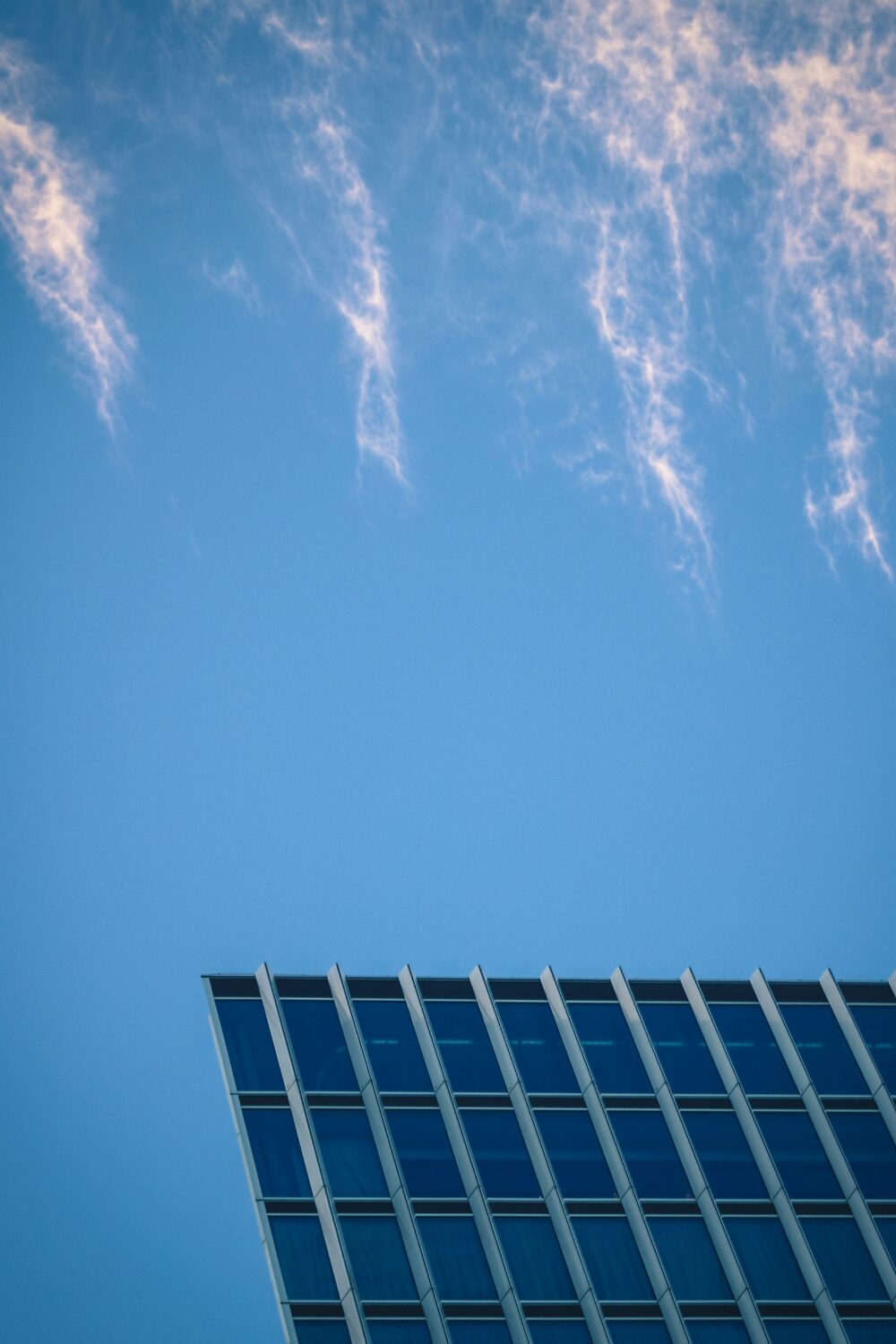 Sheet of solar panels against blue sky
