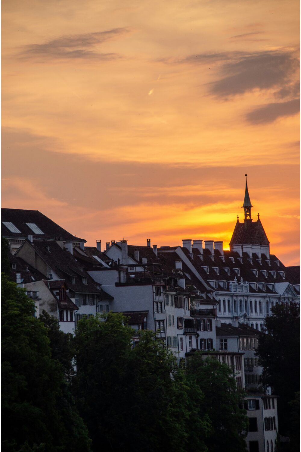 Sunset over medieval town skyline with church steeple