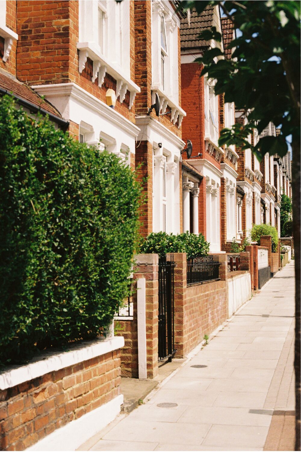 Row of terraced brick houses with white pillar details