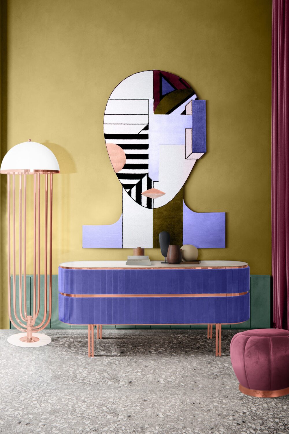 Blue sideboard and rose gold standing lamp against yellow and green wall with abstract face painting