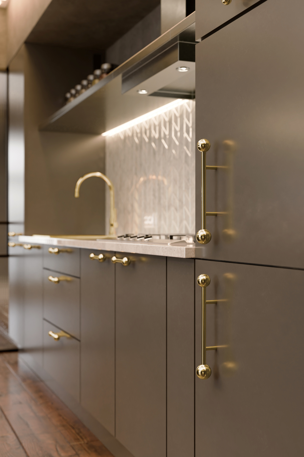 Grey kitchen cabinets with gold hardware and white tiled backsplash