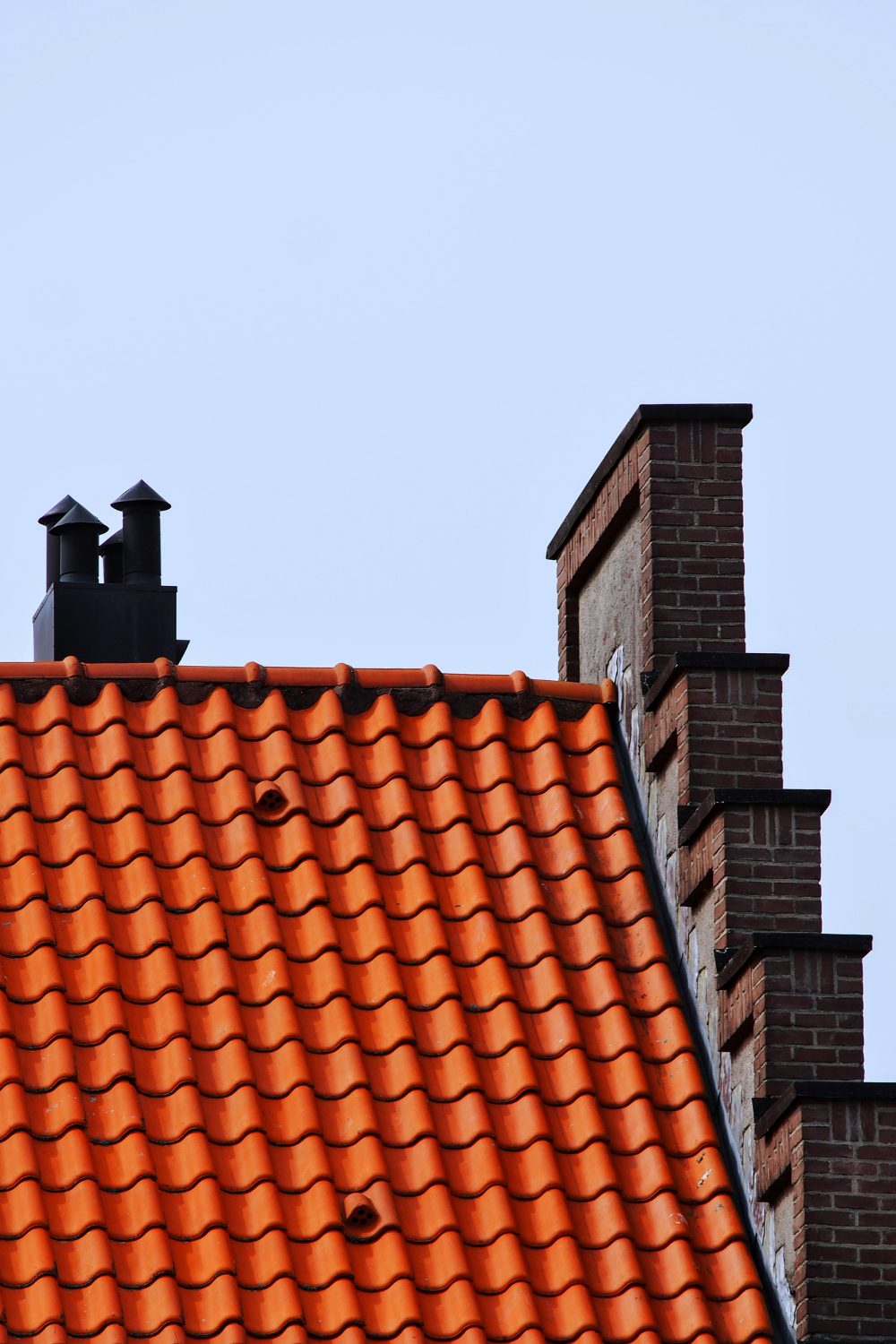 Red-tiled roof with stepped brick frontage