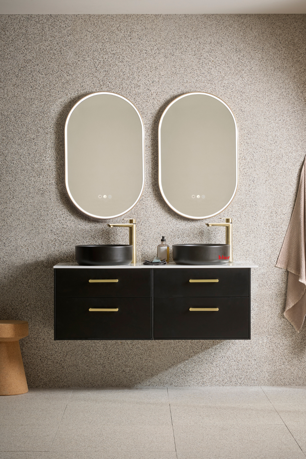 Double sinks and oval mirrors on dark drawers in grey bathroom