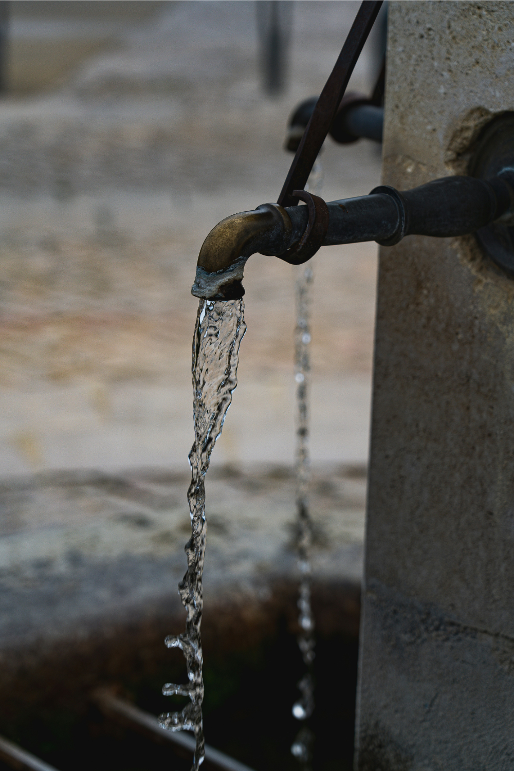 Water flowing from metal tap