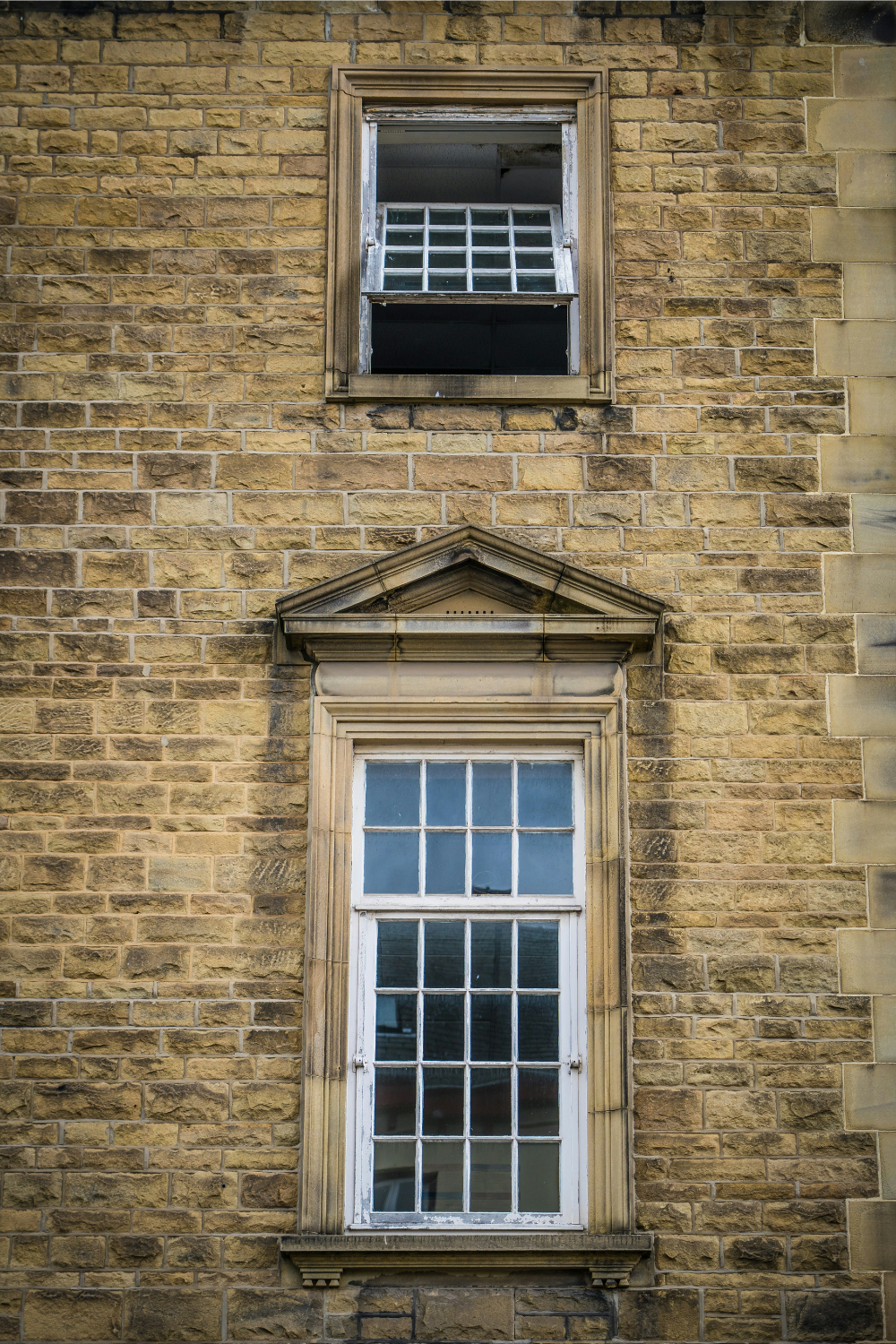 Two sash windows in yellow brick building