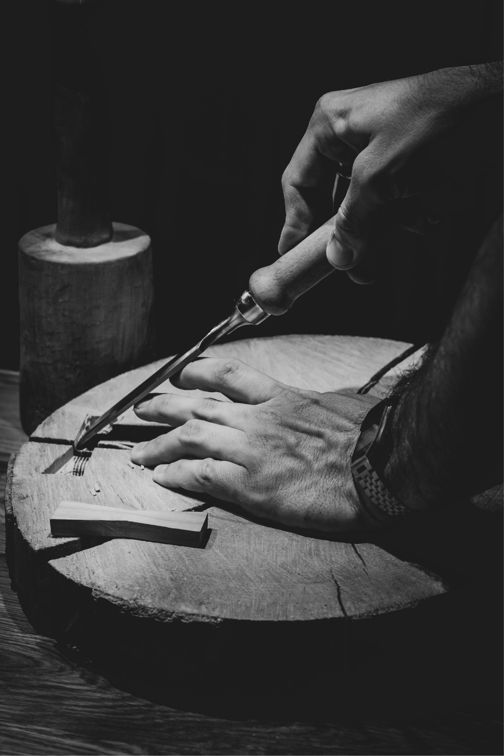 Close-up of hand chiselling a wood panel